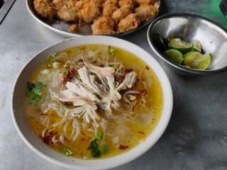 Indonesian chicken soup on an aluminum table
