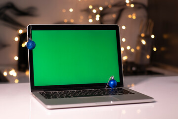laptop with green screen - chromakey near New Year's decorations. christmas theme. template. 