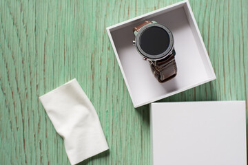 Close up cleaning modern smartwatch with microfiber cloth.