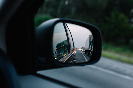 rear view mirror of trucks on highway