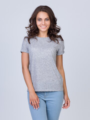 The beautiful girl in a grey t-shirt, she laughs and smiles. Grey t-shirt template