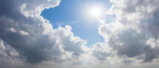 Clouds and blue sky panorama on a sunny day over a lake