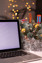 laptop with white screen near New Year's decorations. christmas theme. template. 