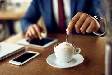 Close-up of businessman having cup of coffee in a cafe,
