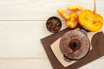 The process of cooking pumpkin casserole on a white wooden background.