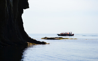 Kiselev rock and sea. People ride SAP surfing and boating.