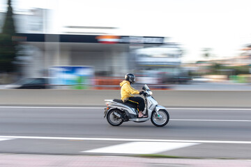 Naklejka premium Barcelona, Spain; May 5, 2017: Panning of one fast scooter in the city. People S