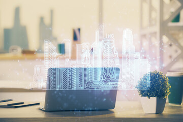 Desktop computer background in office and big town buildings hologram drawing. Double exposure. Smart city concept.