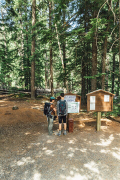 Two hikers at a Trailhead Self-Service Pay station