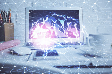 Double exposure of work space with computer and human brain drawing hologram. Brainstorm concept.