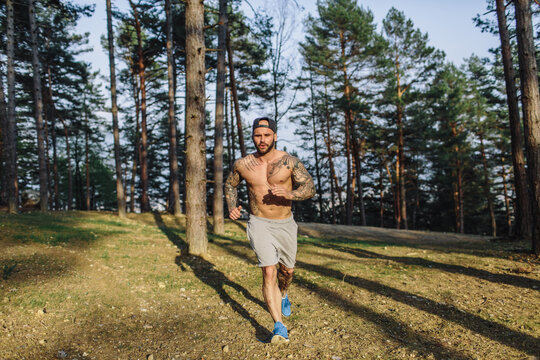 Sporty Tattooed Man Running