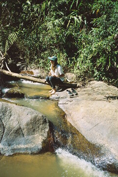 Young girl enjoying a sunny day at the river