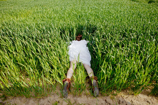 Woman being playful in a field