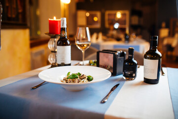 Restaurant table served with tagliatelle with wild mushrooms