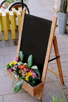 Chalkboard sign with flowers at the entrance