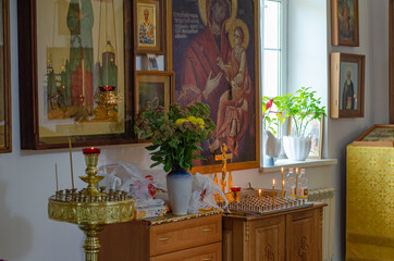 Interior of a Christian Orthodox Church in Russia. Candles, icons, and flowers. The religious concept.