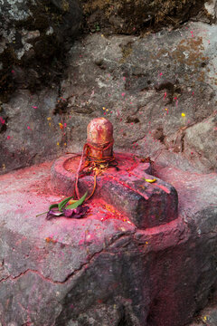 Shiva Ling covered in vermillion.