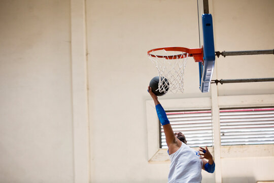 Basketball player reaching for a layup