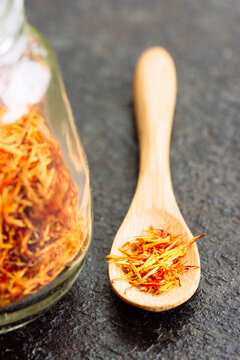 Saffron threads on tiny wooden spoon