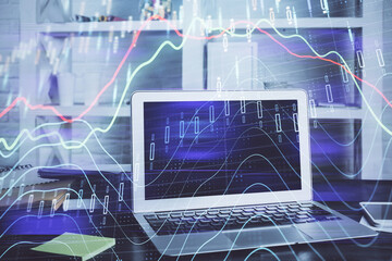 Forex market chart hologram and personal computer background. Multi exposure. Concept of investment.