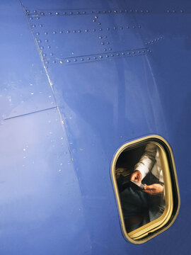 Man Using His Phone on a Plane