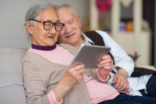 senior asian couple using smart phone indoor