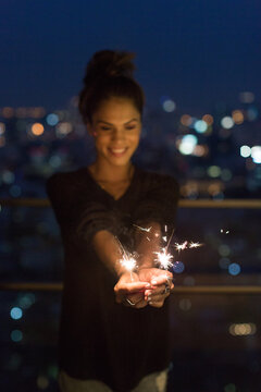 Woman holding sparklers celebrating