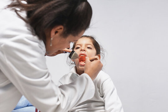 Doctor examining a sore throat