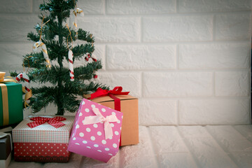 gift box decor at silent night with Christmas tree and ornament, light up white background. Merry christmas and happy new year night.