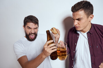 Two friends drink beer leisure fun alcohol friendship lifestyle light background