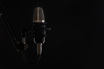 Professional studio microphone on black background. Backstage of recording voices in music studio....