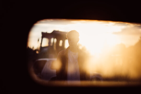 Portrait of hip woman through the car glass