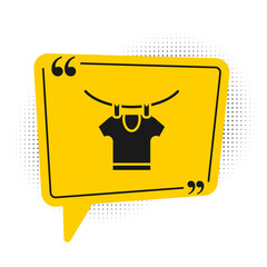 Black Drying clothes icon isolated on white background. Clean shirt. Wash clothes on a rope with clothespins. Clothing care and tidiness. Yellow speech bubble symbol. Vector.