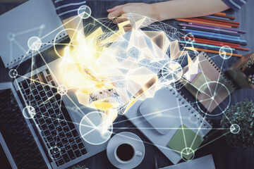 Multi exposure of writing hand on background with brain hologram. Concept of self learning.