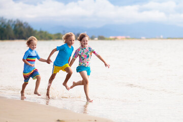 Kids playing on beach. Children play at sea.