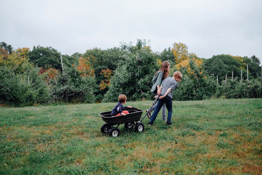 kids pulling wagon with little brother in it