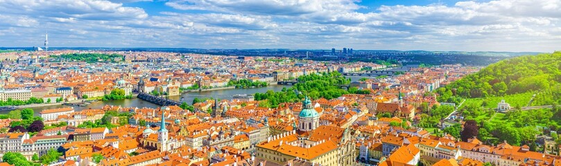 Fototapeta na wymiar Panorama of Prague city. Aerial panoramic view of Prague Old Town historical centre, Charles Bridge Karluv Most across Vltava river and Mala Strana Town with red tiled roof buildings, Czech Republic