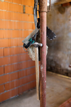 Carpenter's hammer and tools belt hung on building site