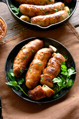 Roasted sausages in frying pan