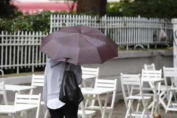 Woman with umbrella walking on a rainy day