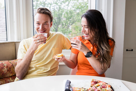 Couple Eating Pizza in Kitchen