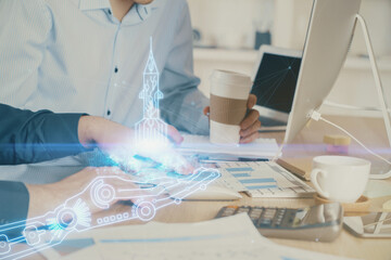Start up drawings with businessman working on computer on background. Teamwork concept. Double...