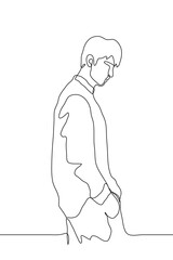 man stands with his hands in his pockets. A drawing of a man in profile in a loose shirt and pants stands pensively