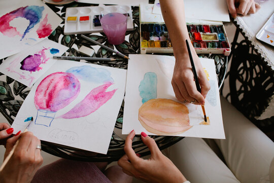 Students making watercolor art in workshop