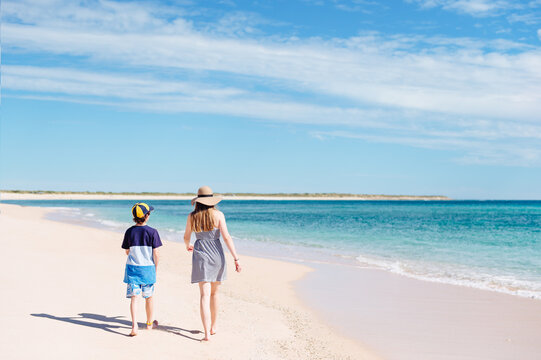 Two children walking together at the beach on the Ningaloo Coast in Western Australia
