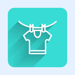 White line Drying clothes icon isolated with long shadow. Clean shirt. Wash clothes on a rope with clothespins. Clothing care and tidiness. Green square button. Vector.