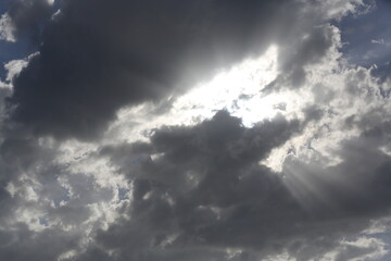 Naklejka na ściany i meble Rays of light reflected through the clouds
