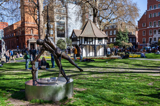 London, UK, April 1, 2012 : Soho Square public park market cross an old fashioned mock architecture building which is a popular open space travel destination tourist attraction landmark of the city