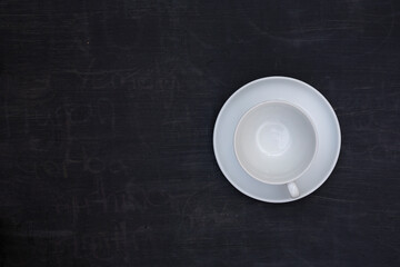 Top view of an empty coffee cup on black wooden table
