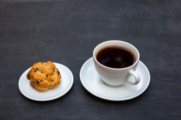 Top view of tea and handmade cookie on black table